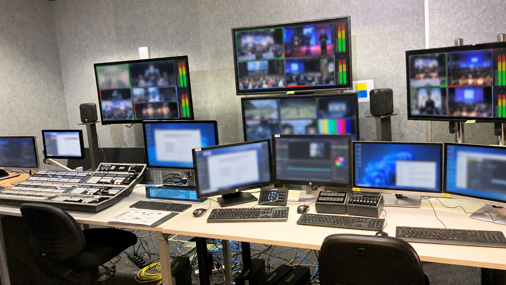Broadcast control room with privacy-blurred multiview and Windows application screens